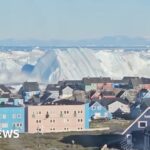Giant iceberg turns over near Greenland's coast