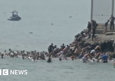 Migrants seen swimming around border fence of Spanish enclave Ceuta