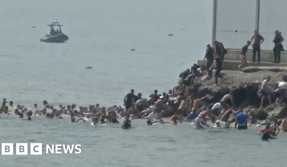 Migrants seen swimming around border fence of Spanish enclave Ceuta