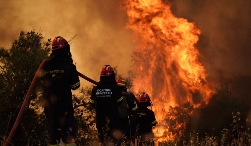 Pictures show firefighters battling raging wildfires in Greece