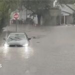 Watch: Flash flooding interrupts half-marathon, submerges cars