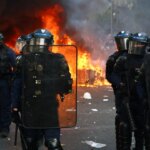 Macron heads to Kuwait for energy talks while France riots rage on
